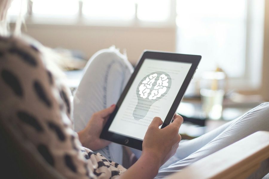 woman sitting in a chair with a laptop in her hands